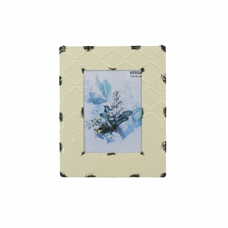 Cream enamelled metal photo frame with quatrefoil relief and brushed black corners, holding a 13 x 18 cm print