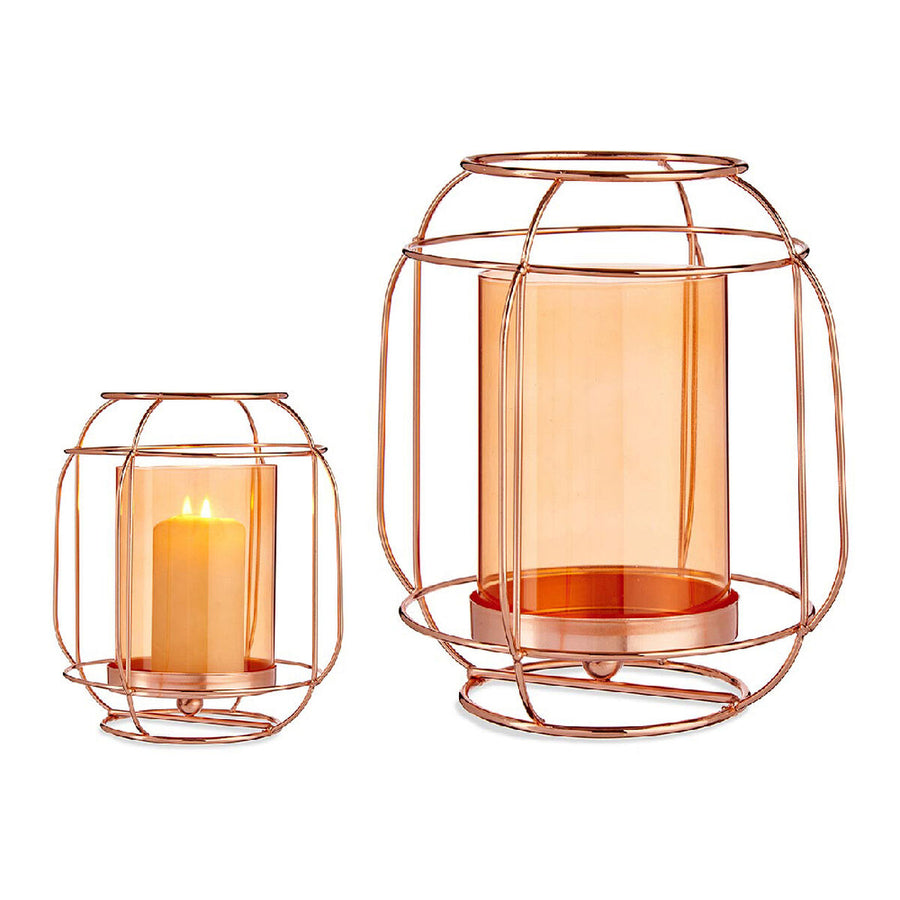 Copper wire candle lantern with an amber glass insert holding a lit candle
