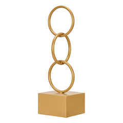 Gold metal ornament of three interlocking rings standing on a cube base